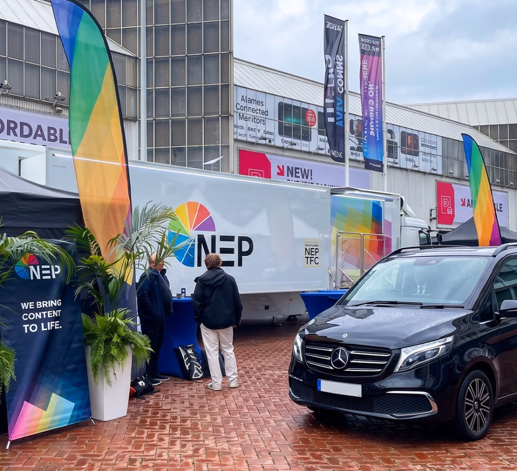 Black Mercedes V-Class business van parked beside exhibitor stands at a trade fair at RAI Amsterdam
