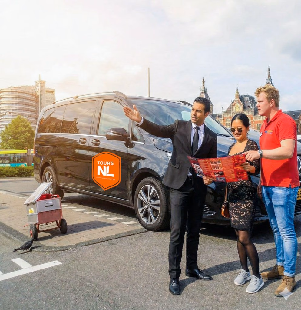 ToursNL private guide welcoming guests beside a luxury Mercedes V-Class van in front of Amsterdam Central Station